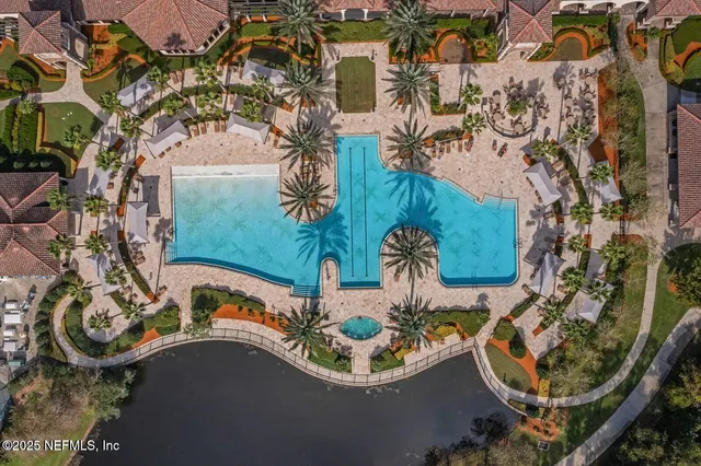 an aerial view of a house with garden space and trees