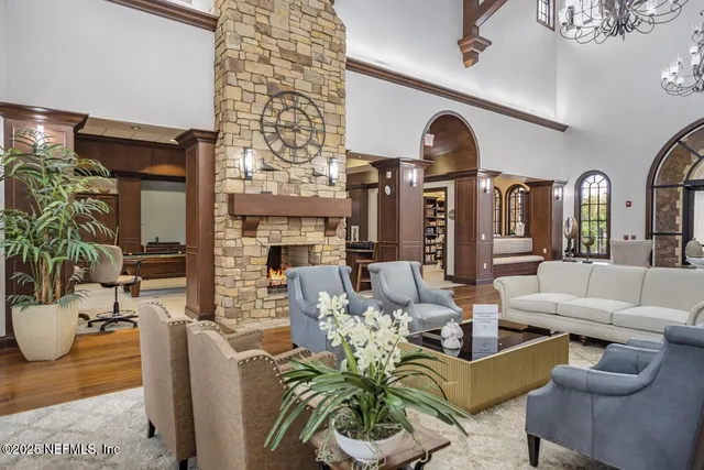a living room with fireplace furniture and a potted plant