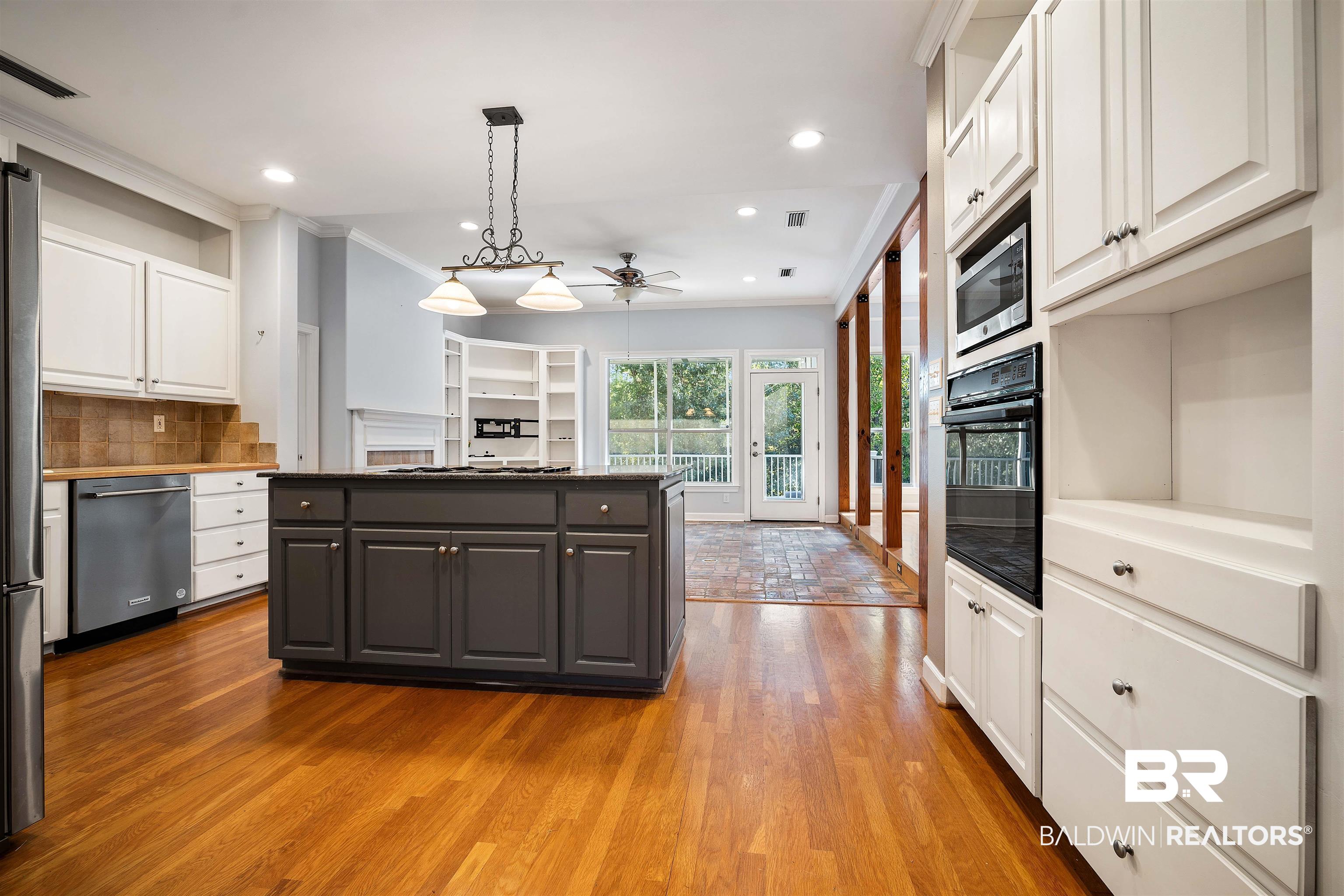 204 General Canby Loop Daphne, AL 36527 - Photo 12 of 36 Kitchen with ceiling fan, pendant lighting, light hardwood / wood-style flooring, stainless steel appliances, and white cabinetry