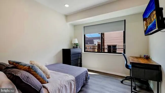 a bedroom with a bed and a bookshelf