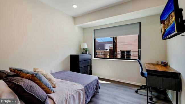 4419 Ludlow Street, Unit 206 Philadelphia, PA 19104 - Photo 8 of 12 a bedroom with a bed and a bookshelf