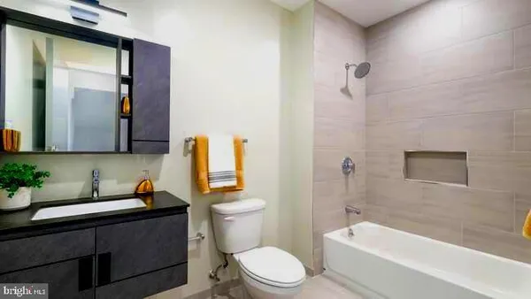 a bathroom with a toilet a sink and bathtub