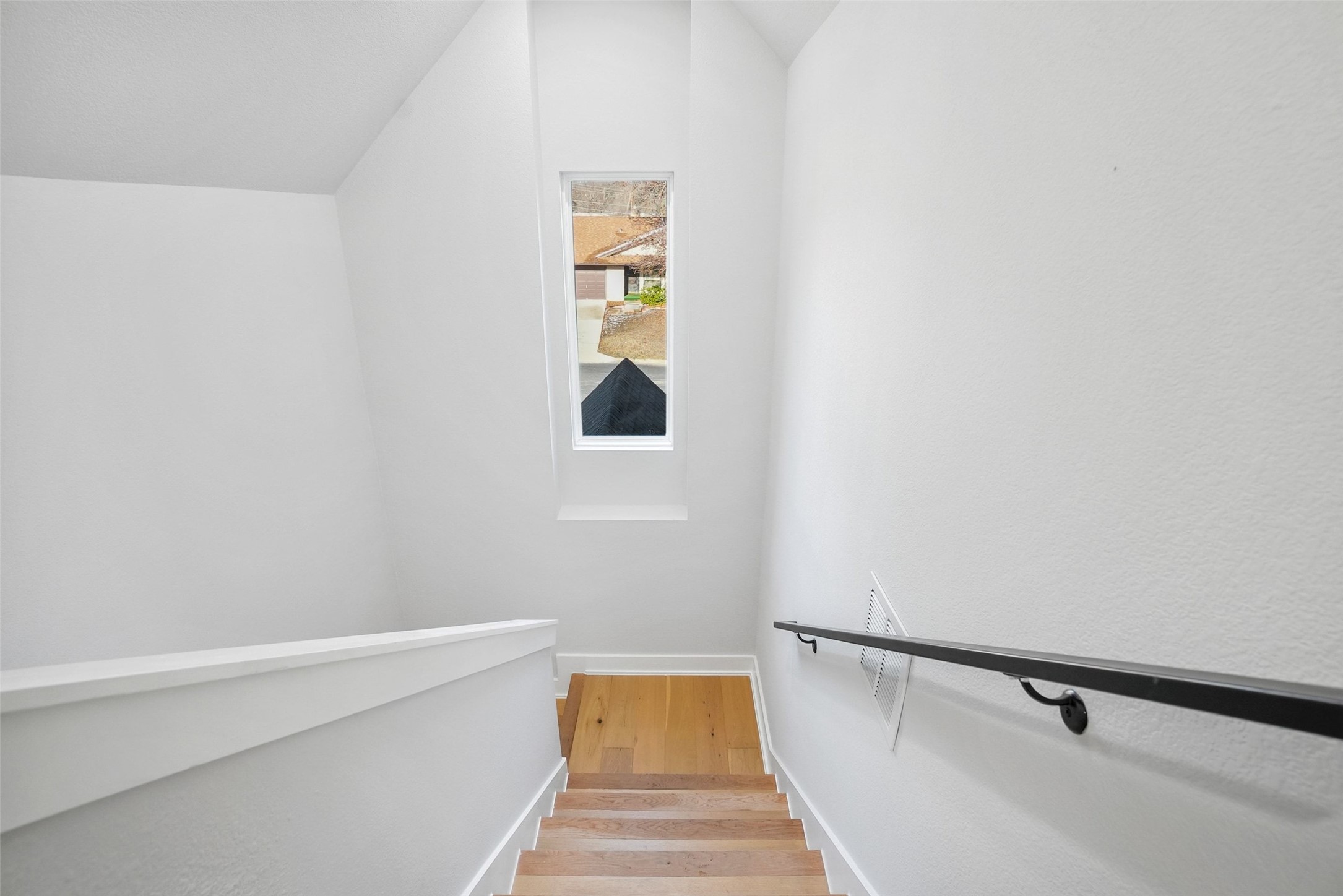 5109 Stone Gate Drive, Unit 2 Austin, TX 78721 - Photo 17 of 23 Stairway with wood finished floors and baseboards