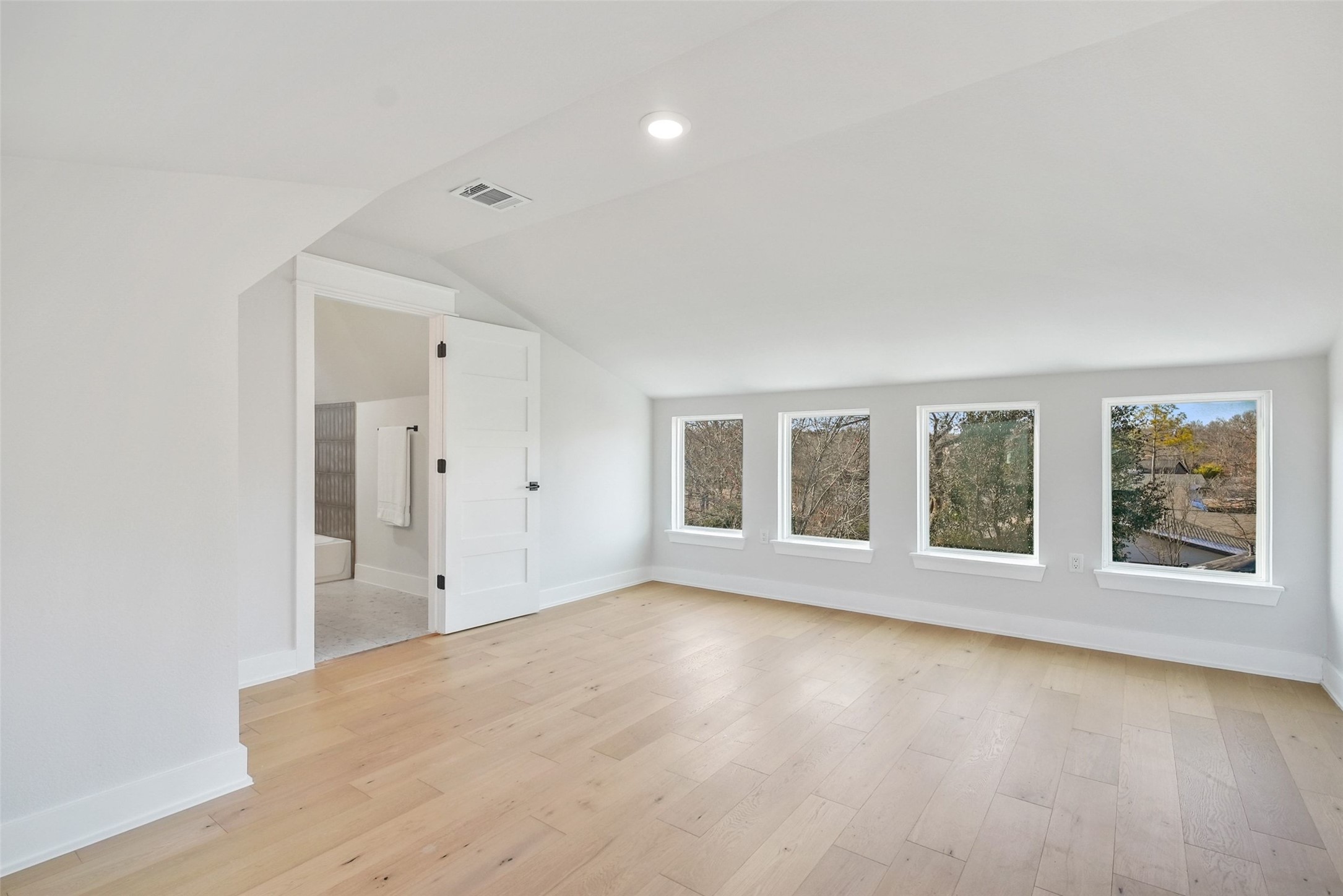 5109 Stone Gate Drive, Unit 2 Austin, TX 78721 - Photo 20 of 23 Additional living space with light wood-style flooring and lofted ceiling