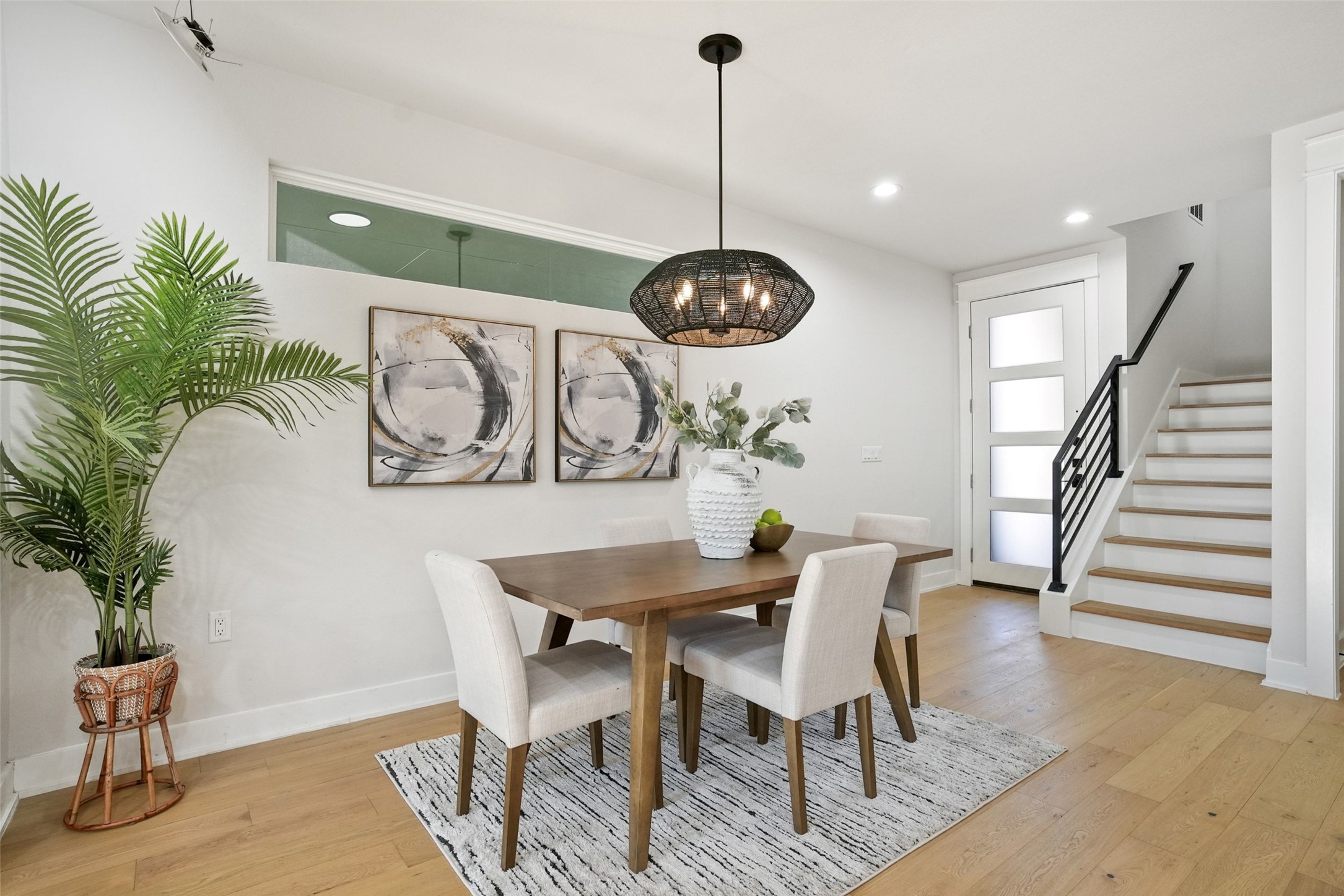 5109 Stone Gate Drive, Unit 2 Austin, TX 78721 - Photo 8 of 23 Dining space with light wood-style floors, stairway, recessed lighting, and a chandelier
