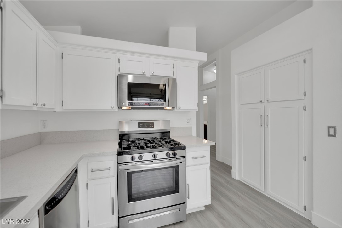 2218 Ramsgate Drive Henderson, NV 89074 - Photo 19 of 33 Kitchen with white cabinetry and stainless steel appliances