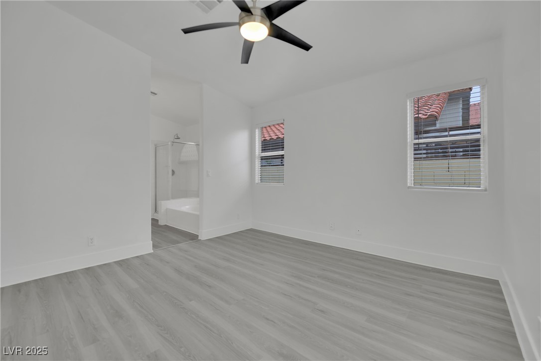 2218 Ramsgate Drive Henderson, NV 89074 - Photo 22 of 33 Empty room with light wood finished floors, baseboards, and a ceiling fan
