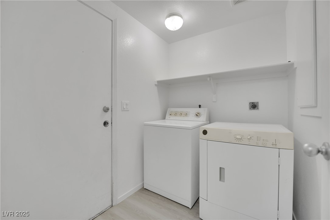2218 Ramsgate Drive Henderson, NV 89074 - Photo 30 of 33 Laundry area with laundry area, washing machine and dryer, and light wood-style floors
