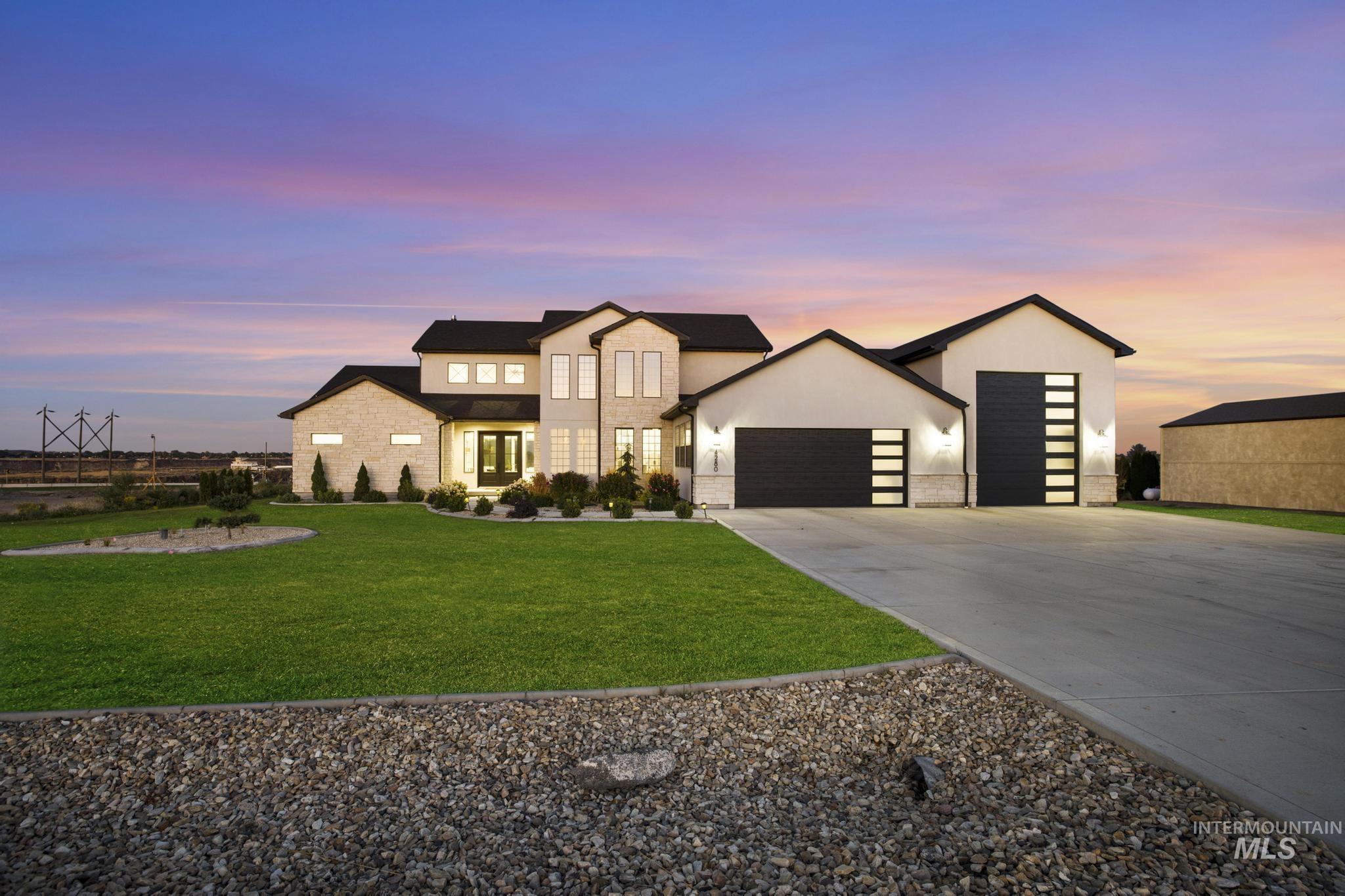Stucco and stone exterior with dark trim accents