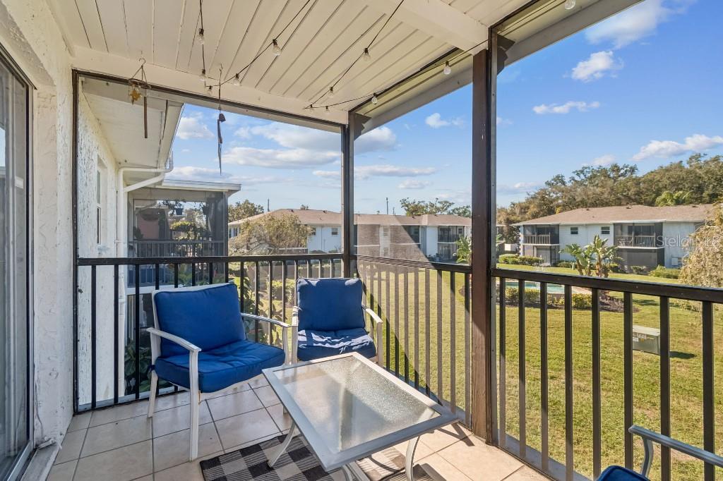 13125 Wilcox Road, Unit 6205 Largo, FL 33774 - Photo 36 of 48 a view of a chair and table in the balcony
