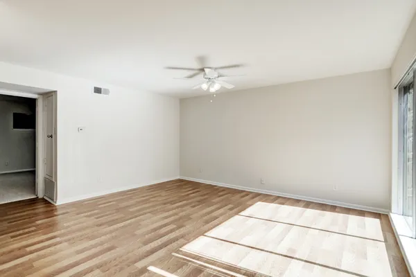 wooden floor in an empty room with a window