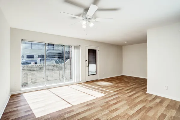 a view of a livingroom with a ceiling fan and window