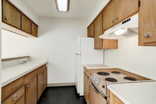 a kitchen that has a sink a stove and a microwave