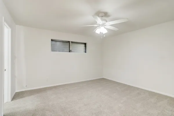 a view of an empty room with a fan