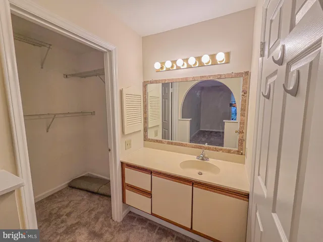 a white toilet and tub sitting next to a bathroom sink