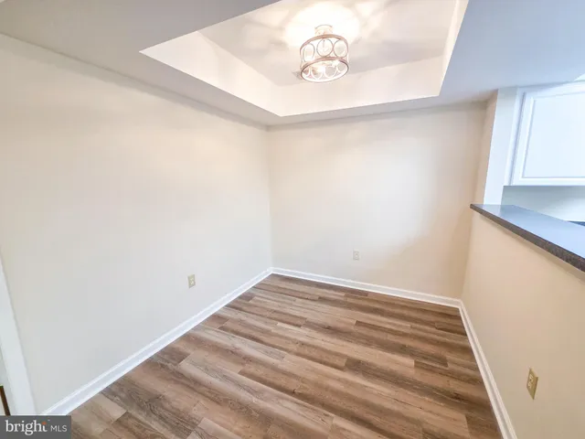 a view of a room with a white wall and a window