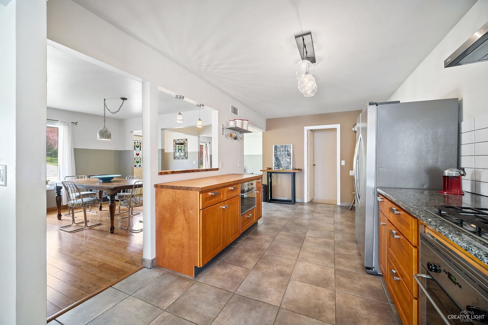 23 Aldon Road Montgomery, IL 60538 - Photo 13 of 31 a large kitchen with stainless steel appliances kitchen island granite countertop a large counter top and dining table