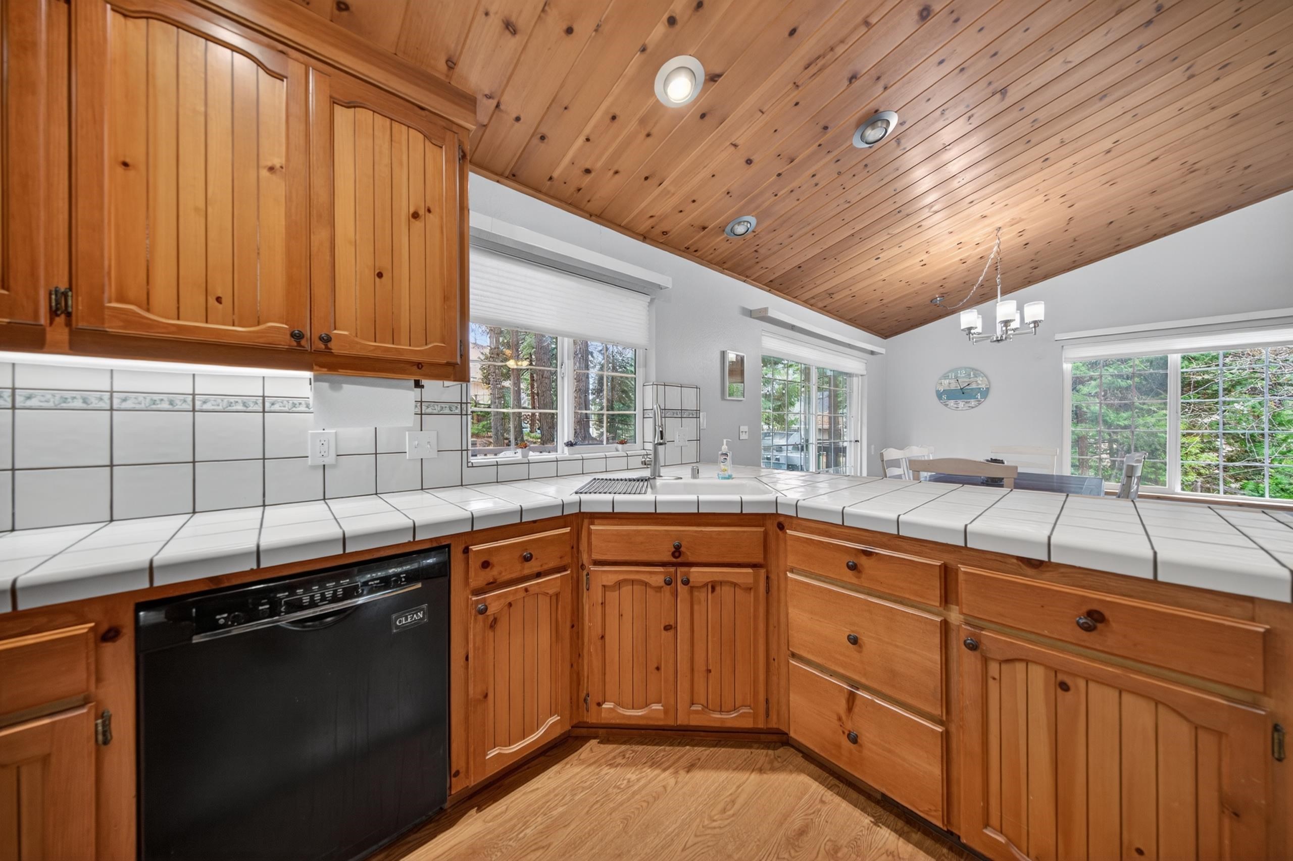 1220 Lynx Road Lake Almanor, CA 96137 - Photo 16 of 45 a kitchen with granite countertop stainless steel appliances a sink window and cabinets