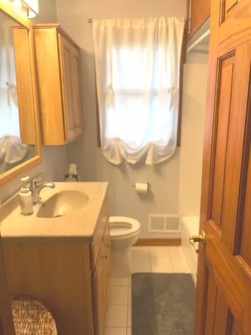 a bathroom with a sink a mirror and a shower