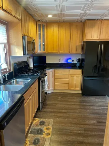 a kitchen with stainless steel appliances granite countertop a sink stove and refrigerator