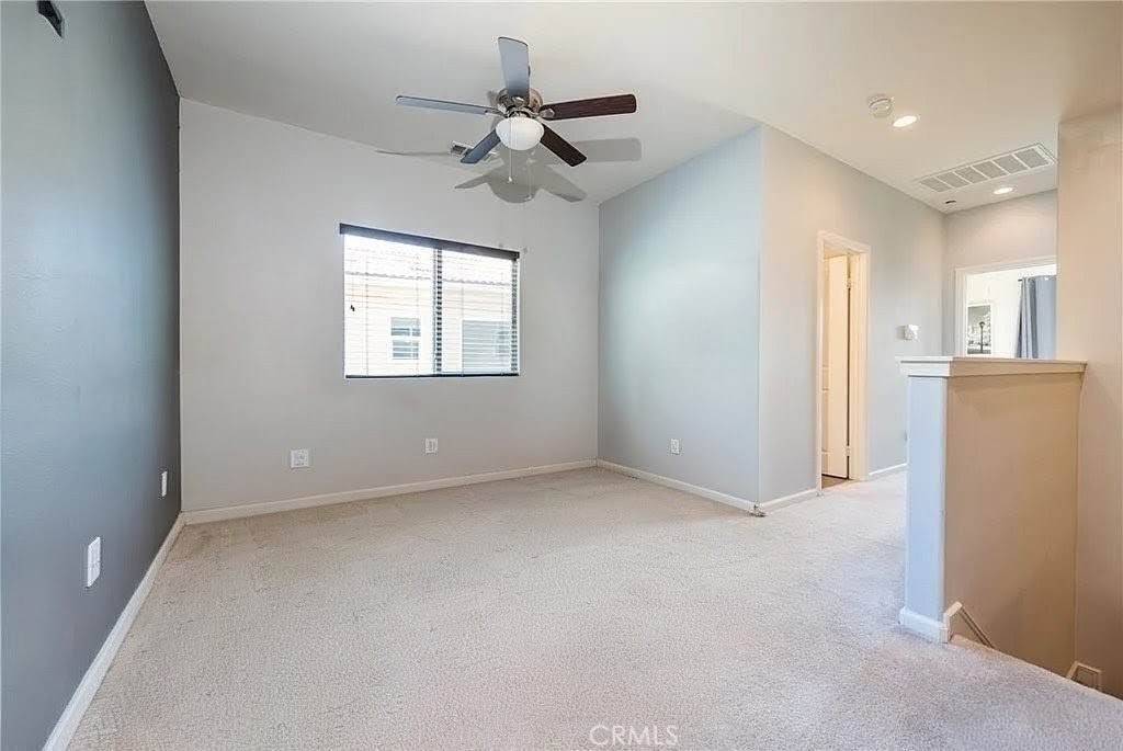 11811 Cramer Road Yucaipa, CA 92399 - Photo 48 of 56 an empty room with a window and a ceiling fan