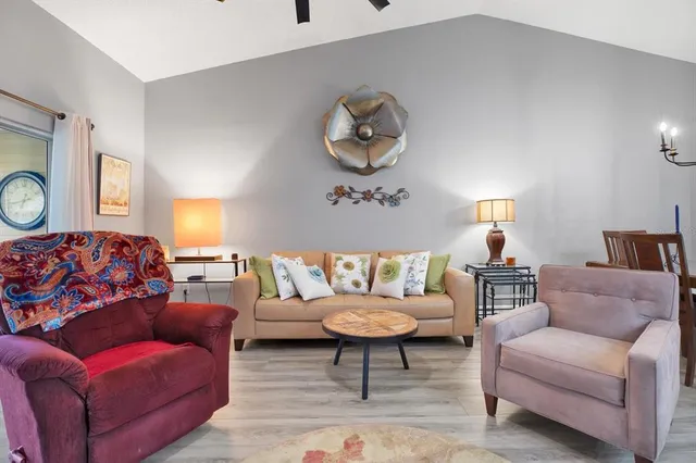 a living room with furniture a rug and a window