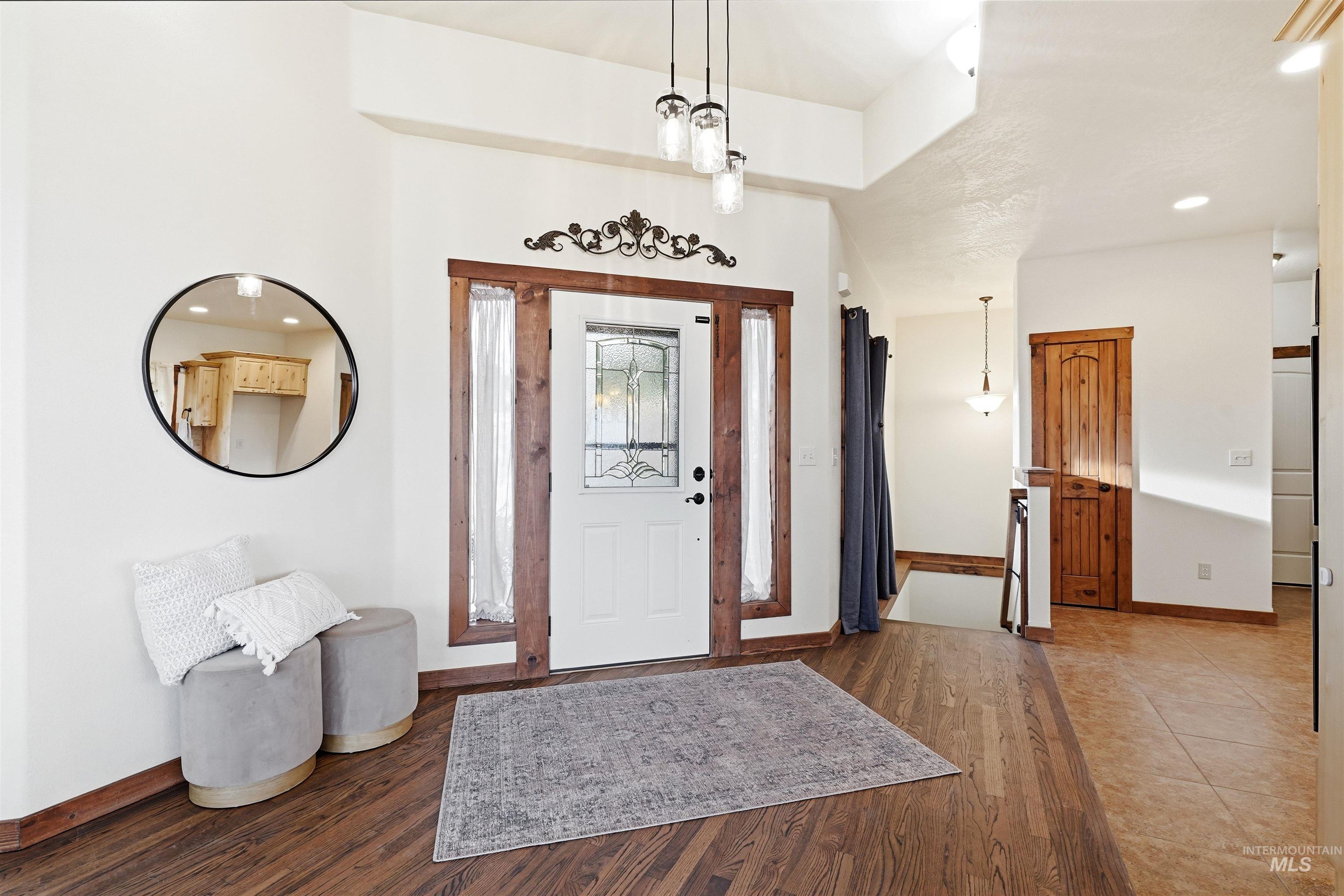 3645 Butte Road Emmett, ID 83617 - Photo 4 of 39 Entryway featuring wood-finish flooring, a white front door with leaded glass, and wood trim