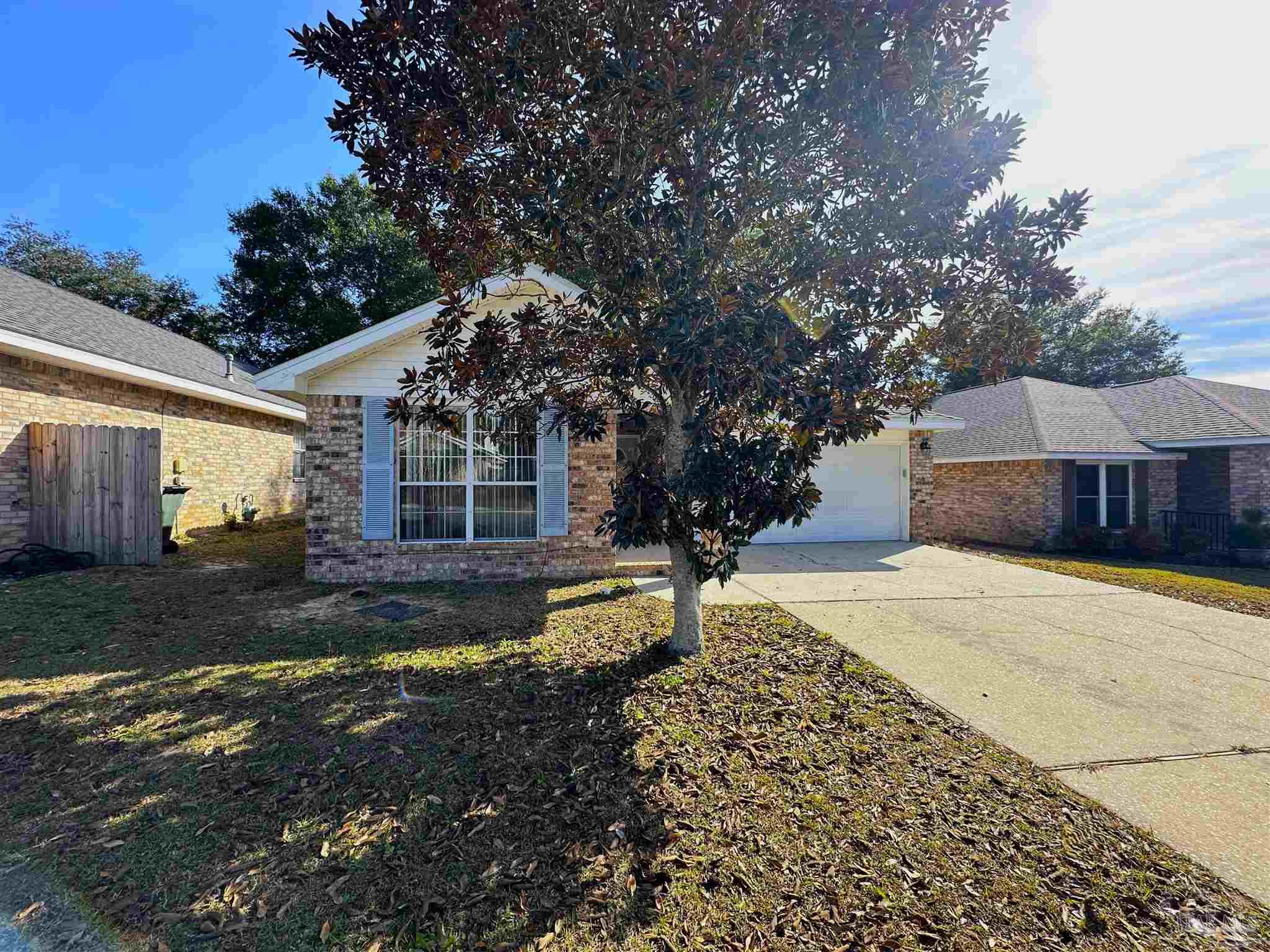 a front view of a house with a yard garage and outdoor seating