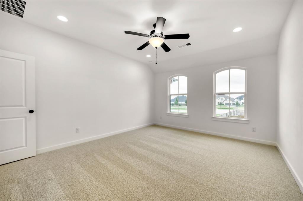 3420 Brocco Road Celina, TX 75009 - Photo 18 of 27 Wall-to-wall carpeting, dual arched windows, recessed lighting, and a ceiling fan with integrated light fixture