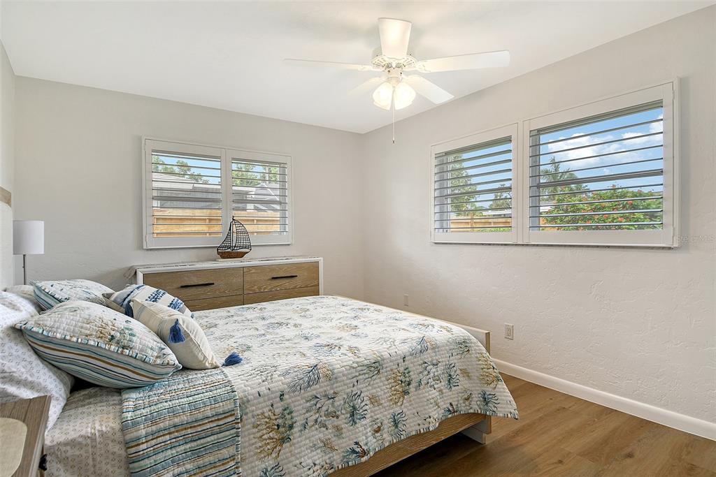 6722 Roxbury Drive Sarasota, FL 34231 - Photo 40 of 87 a bedroom with a bed a dresser and next to a window