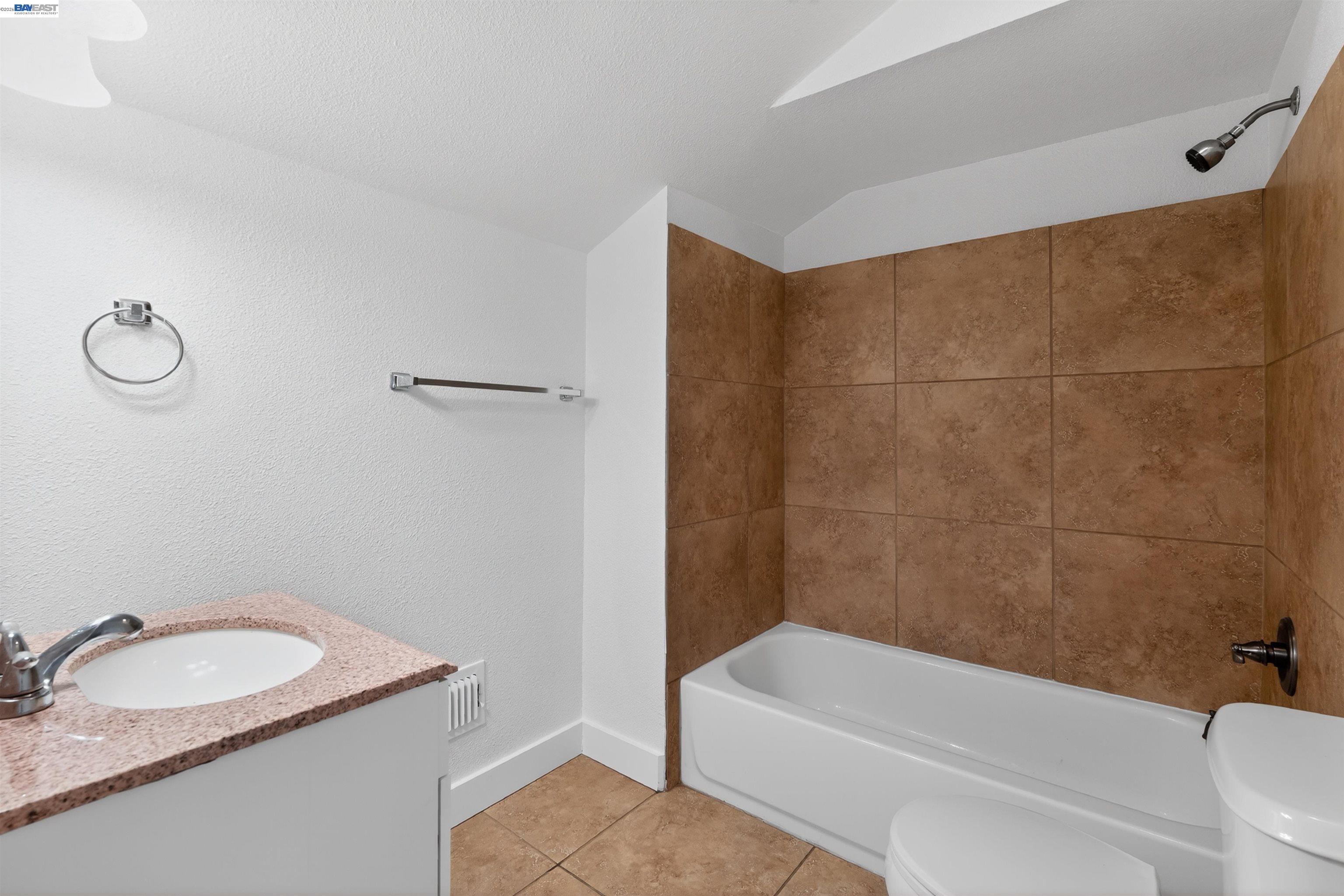 3015 Point Pleasant Road Elk Grove, CA 95757 - Photo 17 of 32 a bathroom with a granite countertop sink a toilet and bathtub