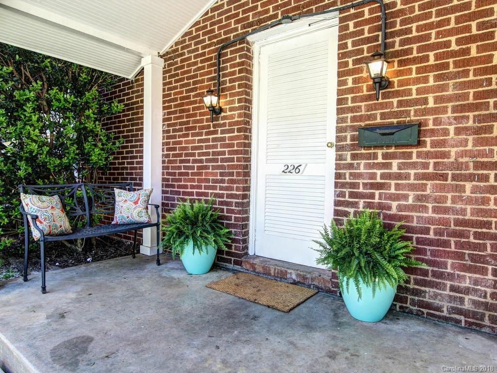 226 Providence Road Charlotte, NC 28207 - Photo 2 of 13 a view of a chair and table in back yard of the house