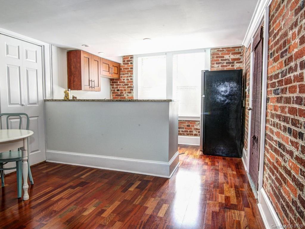 226 Providence Road Charlotte, NC 28207 - Photo 3 of 13 a view of a hallway with wooden floor and staircase