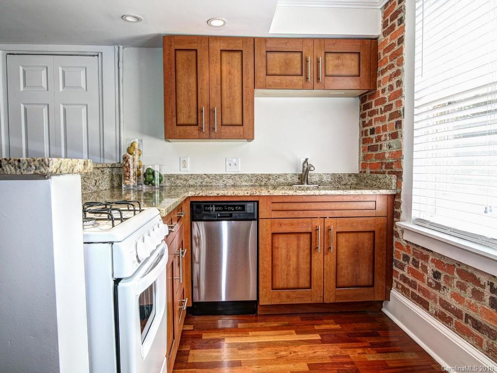 226 Providence Road Charlotte, NC 28207 - Photo 4 of 13 a kitchen with stainless steel appliances granite countertop a stove a sink and a refrigerator