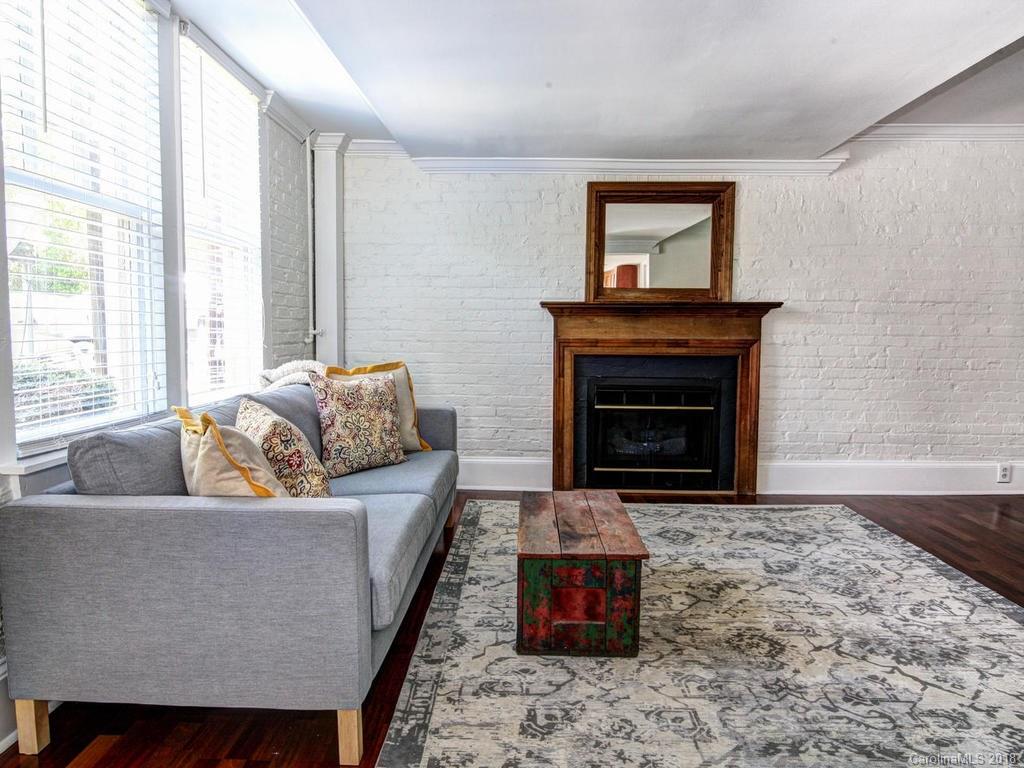 226 Providence Road Charlotte, NC 28207 - Photo 6 of 13 a living room with furniture and a fireplace
