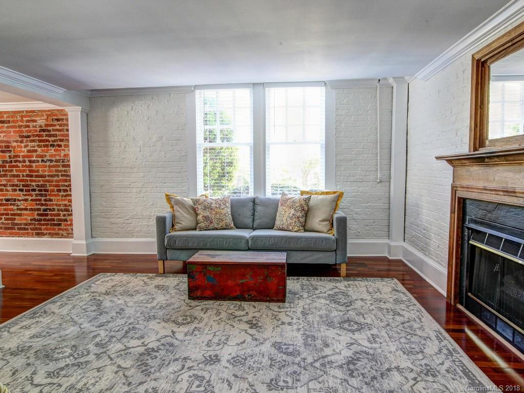 226 Providence Road Charlotte, NC 28207 - Photo 7 of 13 a living room with furniture and a fireplace