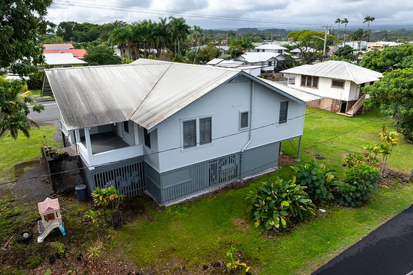 a aerial view of a house with a yard and lake view