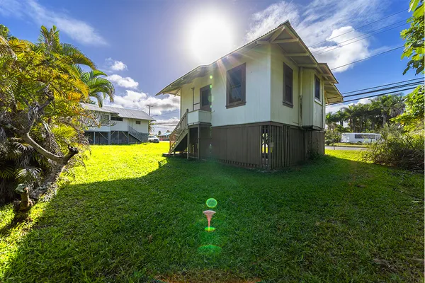 a view of an house with backyard and a swimming pool