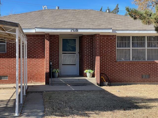 1518 South Drake Street Perryton, TX 79070 - Photo 2 of 13 a front view of a house with a garage