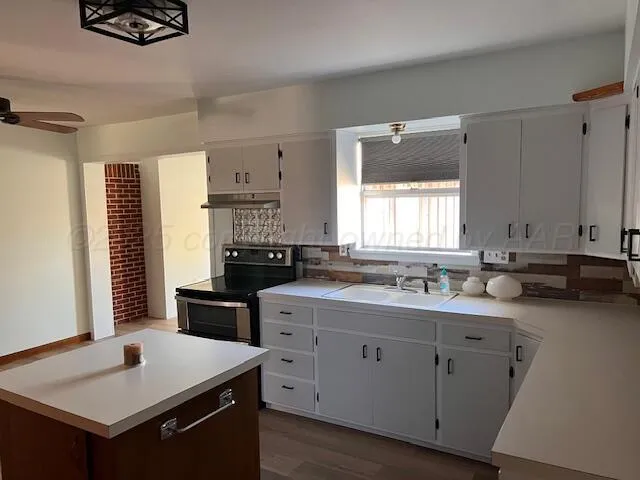 a kitchen with a sink stove and cabinets