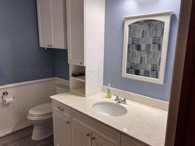 1518 South Drake Street Perryton, TX 79070 - Photo 8 of 13 a bathroom with a sink toilet and vanity