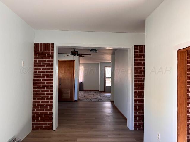 1518 South Drake Street Perryton, TX 79070 - Photo 10 of 13 a view of hallway with wooden floor