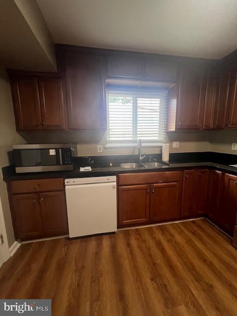 16 Brian Court, Unit 245 Gaithersburg, MD 20877 - Photo 5 of 22 a kitchen with granite countertop a sink a stove cabinets and wooden floor