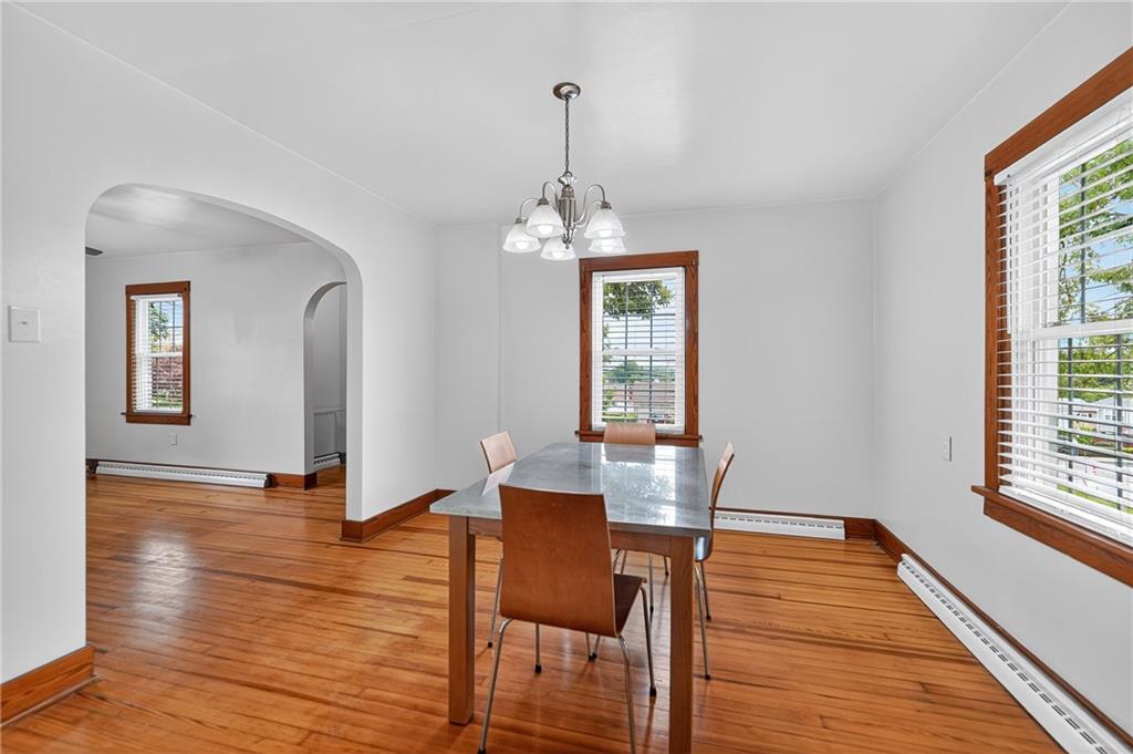 1605 Maratta Road Aliquippa, PA 15001 - Photo 13 of 34 a dining room with wooden floor a chandelier a glass table and chairs