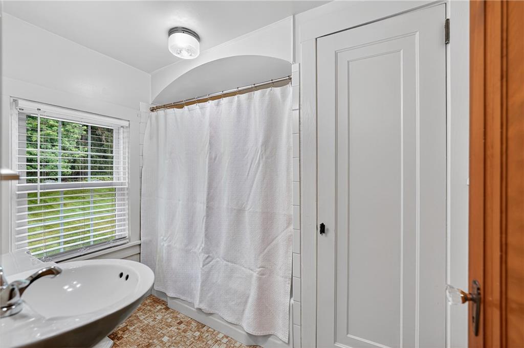 1605 Maratta Road Aliquippa, PA 15001 - Photo 30 of 34 a bathroom with a granite countertop sink a mirror and a shower