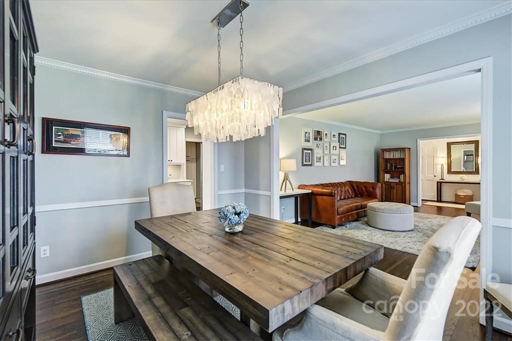 3021 Eastburn Road Charlotte, NC 28210 - Photo 11 of 48 a view of a dining room with furniture a chandelier and wooden floor