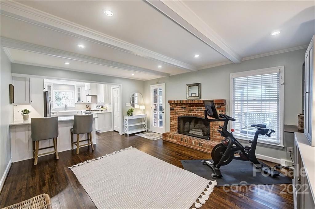 3021 Eastburn Road Charlotte, NC 28210 - Photo 12 of 48 a living room with furniture a fireplace and kitchen view