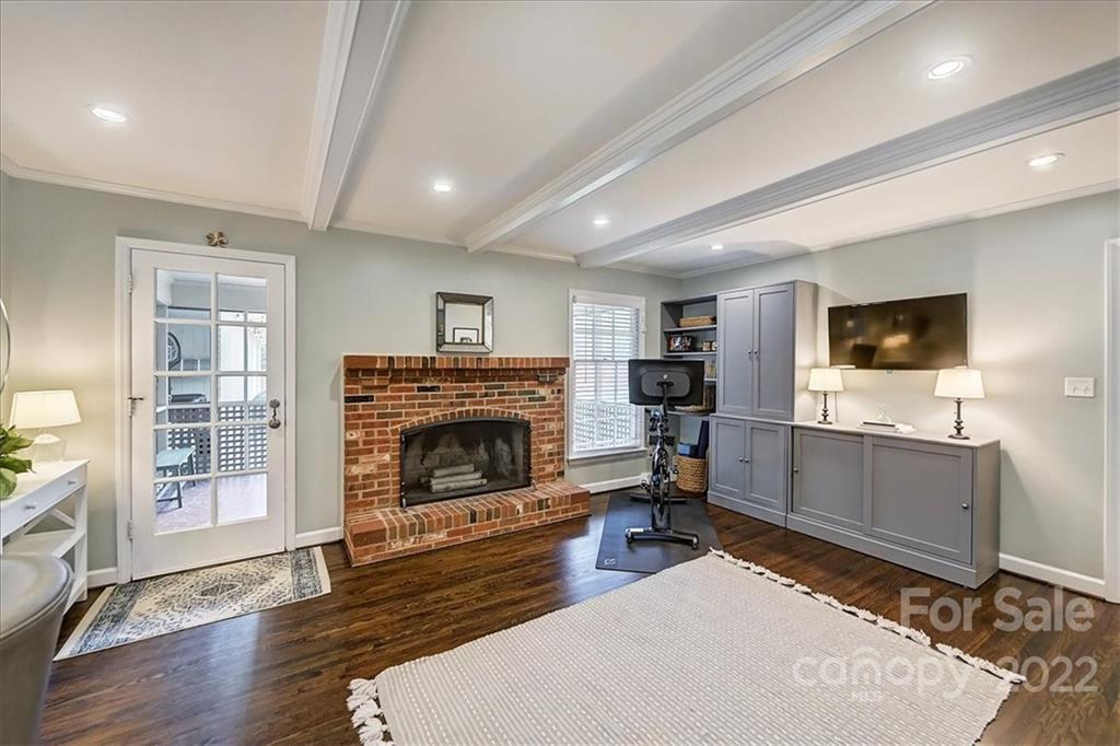 3021 Eastburn Road Charlotte, NC 28210 - Photo 15 of 48 a living room with furniture a flat screen tv and a fireplace