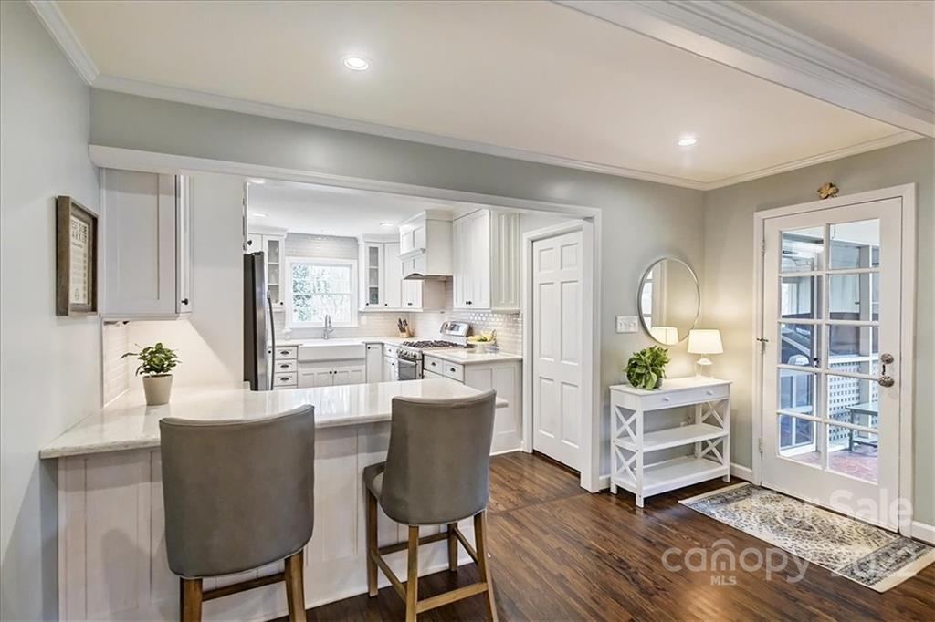 3021 Eastburn Road Charlotte, NC 28210 - Photo 18 of 48 a kitchen with a dining table chairs and refrigerator