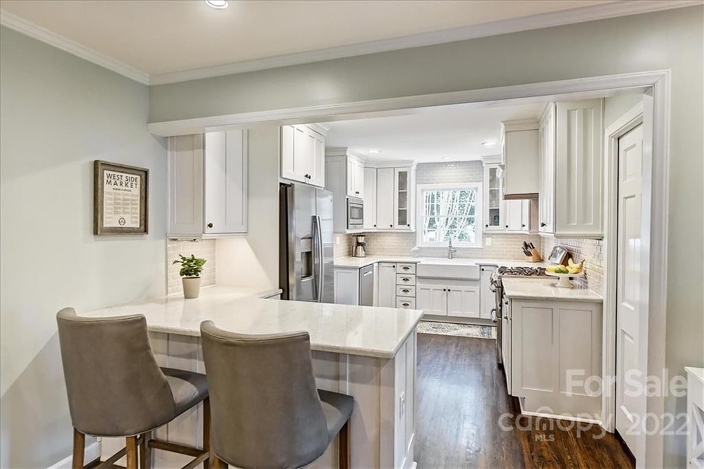 3021 Eastburn Road Charlotte, NC 28210 - Photo 19 of 48 a dining hall with stainless steel appliances kitchen island granite countertop a dining table and chairs